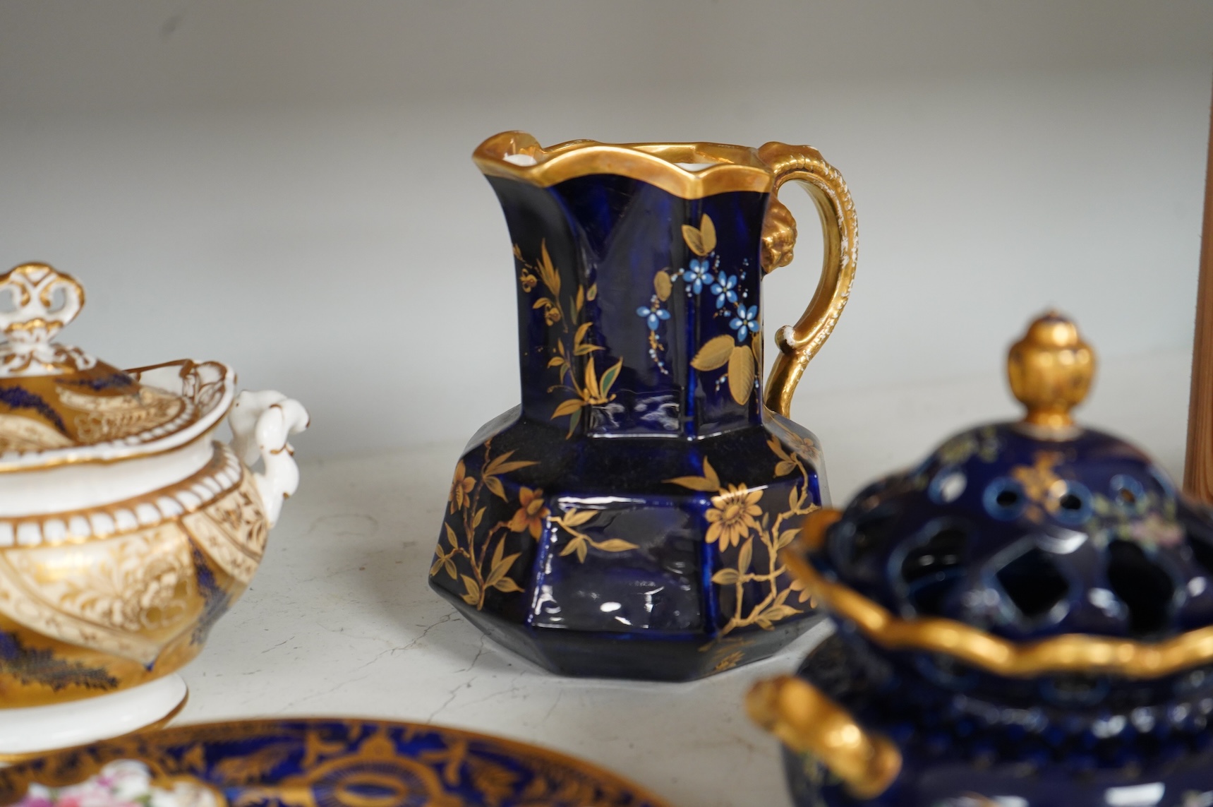 A Group of early 19th century English porcelain; to sauce tureens and covers, one with stand, a covered sugar bowl, a two handled vase, a pot pourri vase and cover, a milk jug and a hydra shaped jug, largest 16cm high